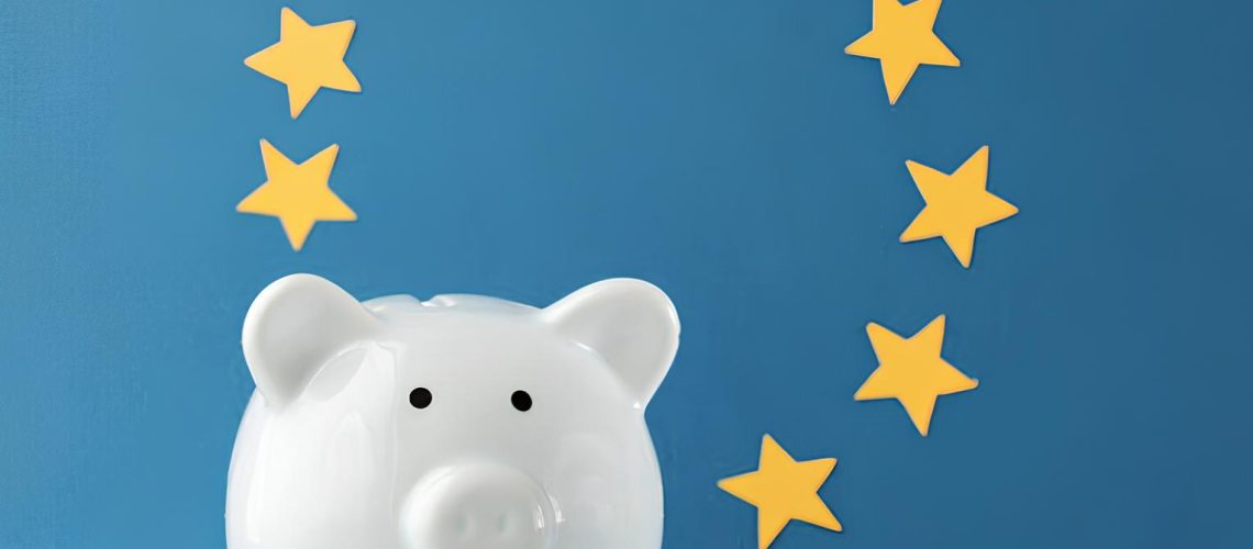 Piggy bank in blue against the background of the european flag (1)